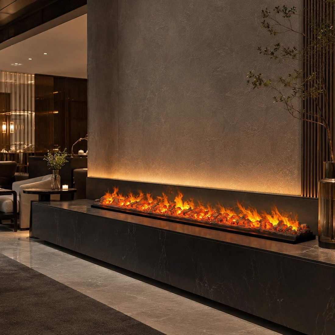 A long electric fire set into a black marble bench in a softly lit hotel lobby.